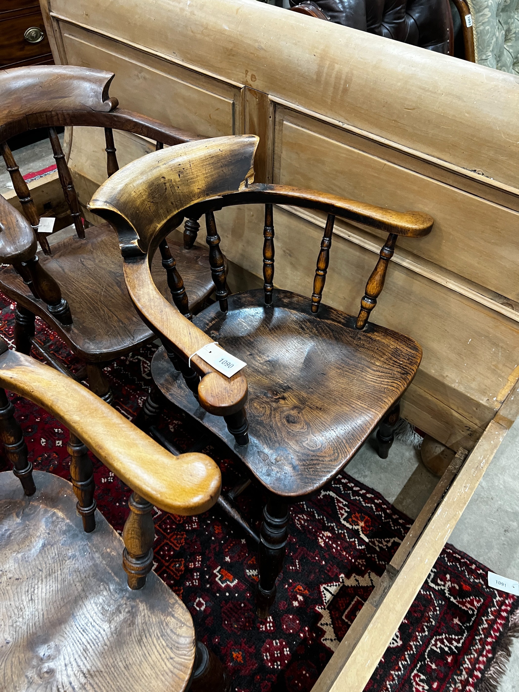 A harlequin set of five Victorian elm and beech smoker's bow chairs